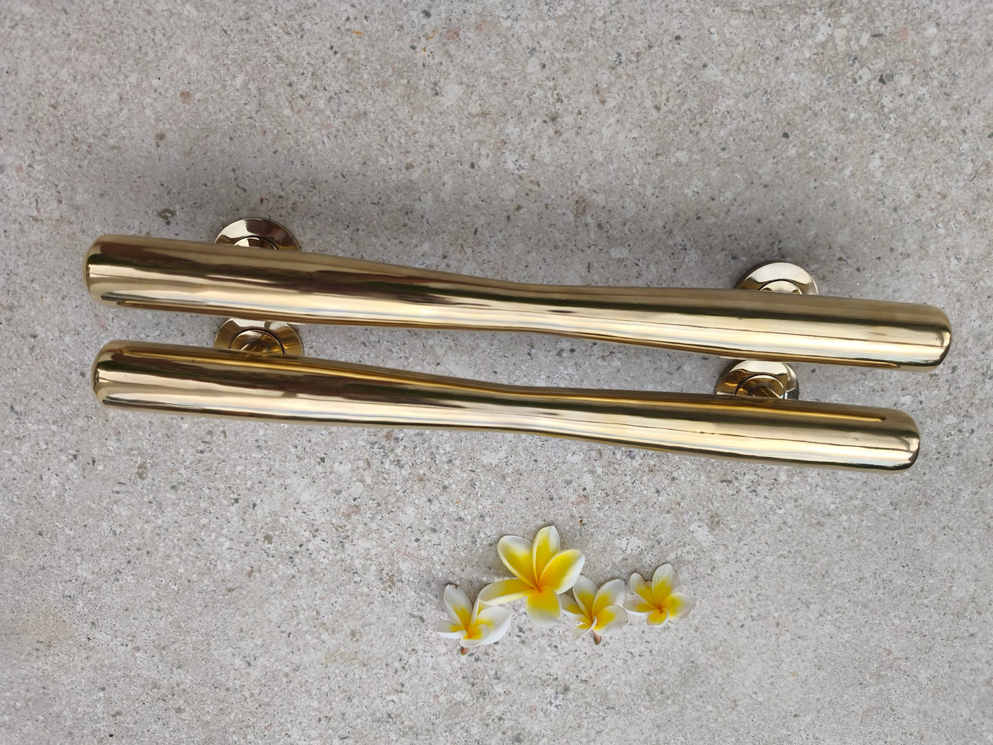 Profile view of two brass door pull handles lying flat, showing the mounting posts and 24 cm screw spacing of this solid brass gold door hardware