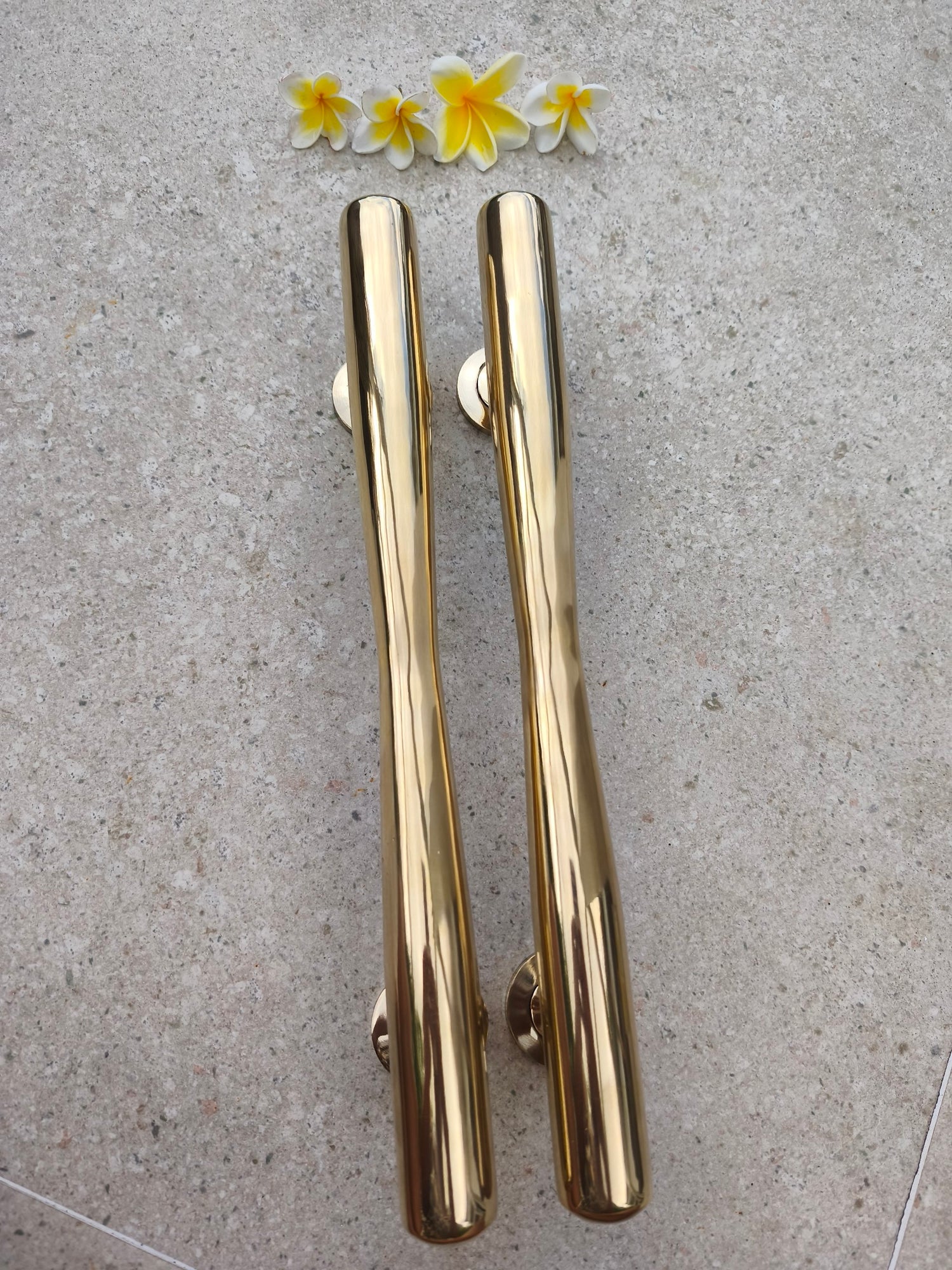 Two solid brass door pulls side by side, polished gold 40 cm tapered handles for modern, classic and tropical style front doors