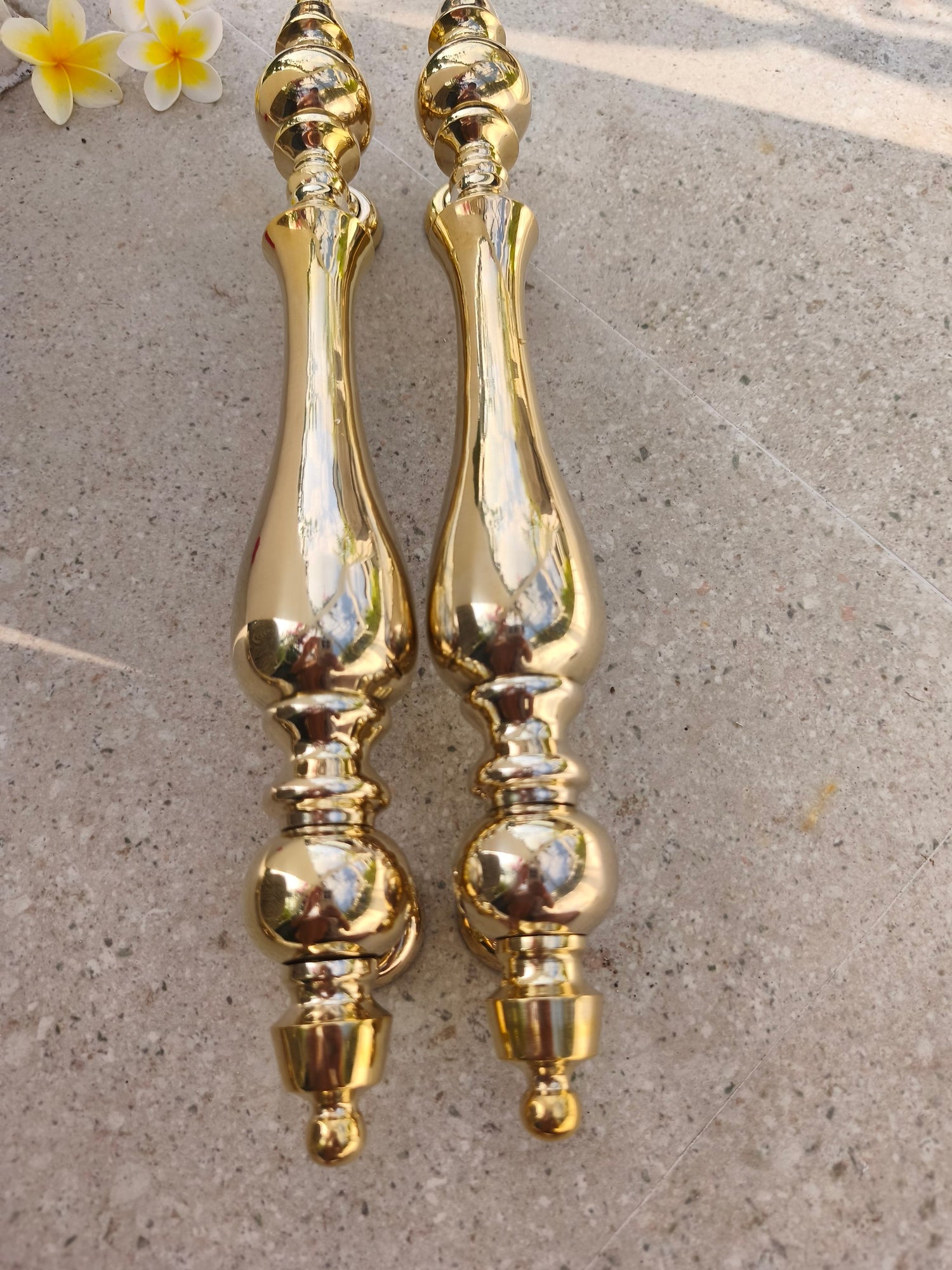 Long polished brass door pull handle with classic European styling, gold entrance door hardware that brings an elegant, timeless, high end look to a home exterior